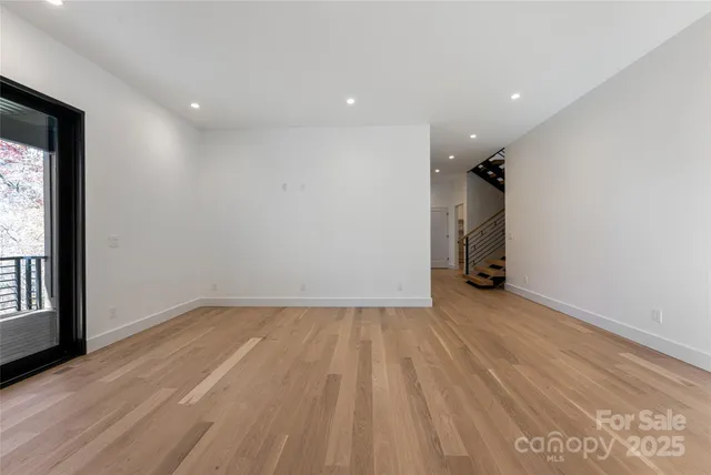 a view of backyard with large tree and wooden fence