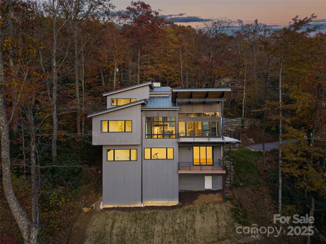 a front view of a house with barbeque oven and outdoor seating