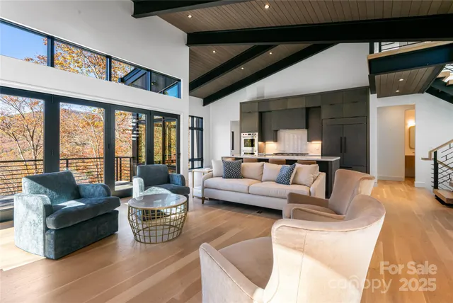 a living room with furniture a large window and a fireplace