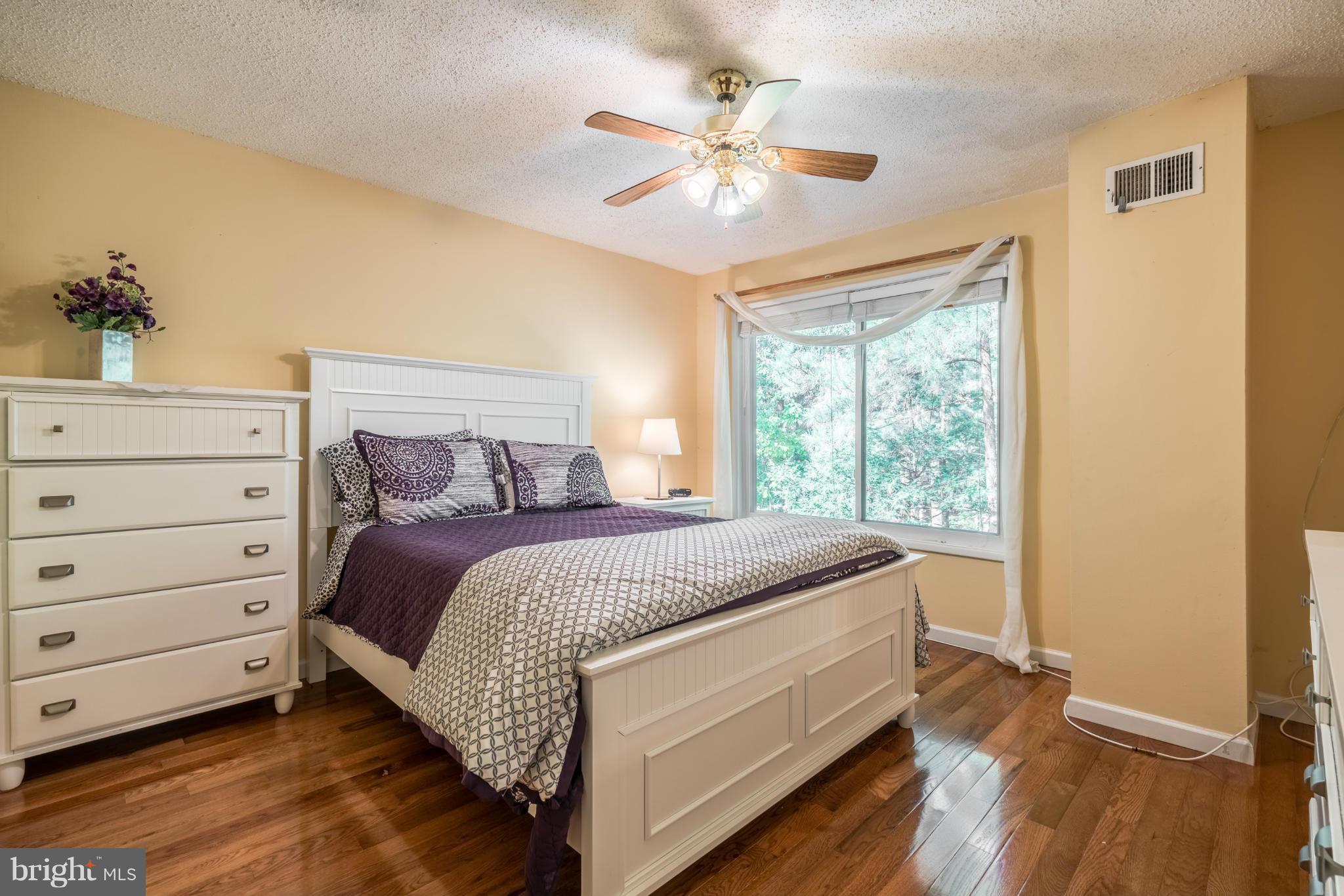 2402 Southgate Square Reston, VA 20191 - Photo 11 of 21 a bed room with a bed and a chandelier