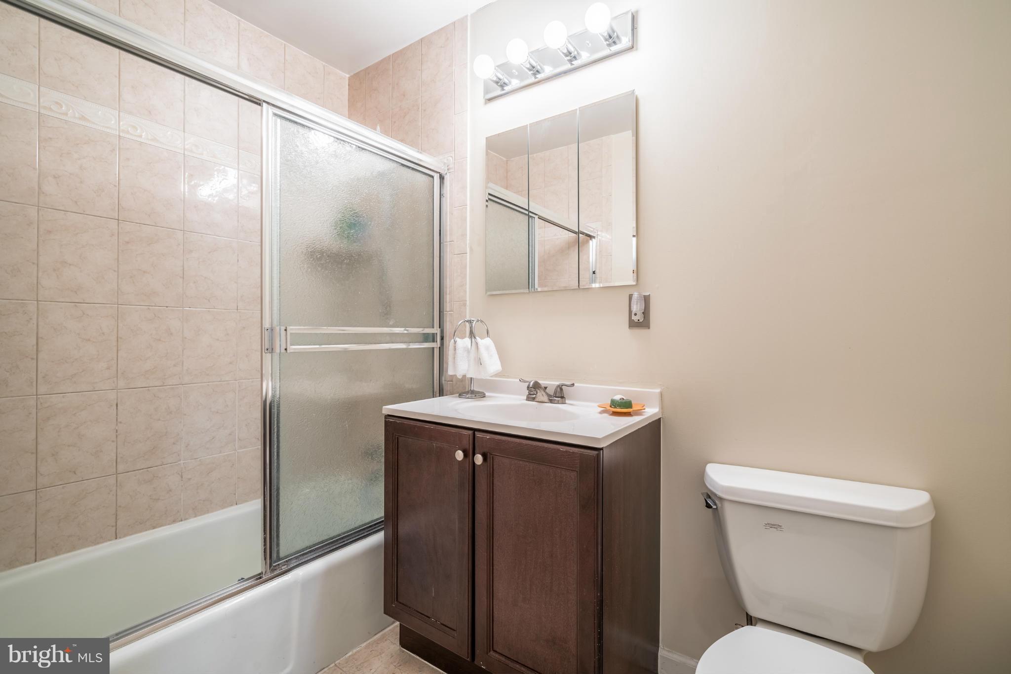 2402 Southgate Square Reston, VA 20191 - Photo 13 of 21 a bathroom with a toilet sink and shower