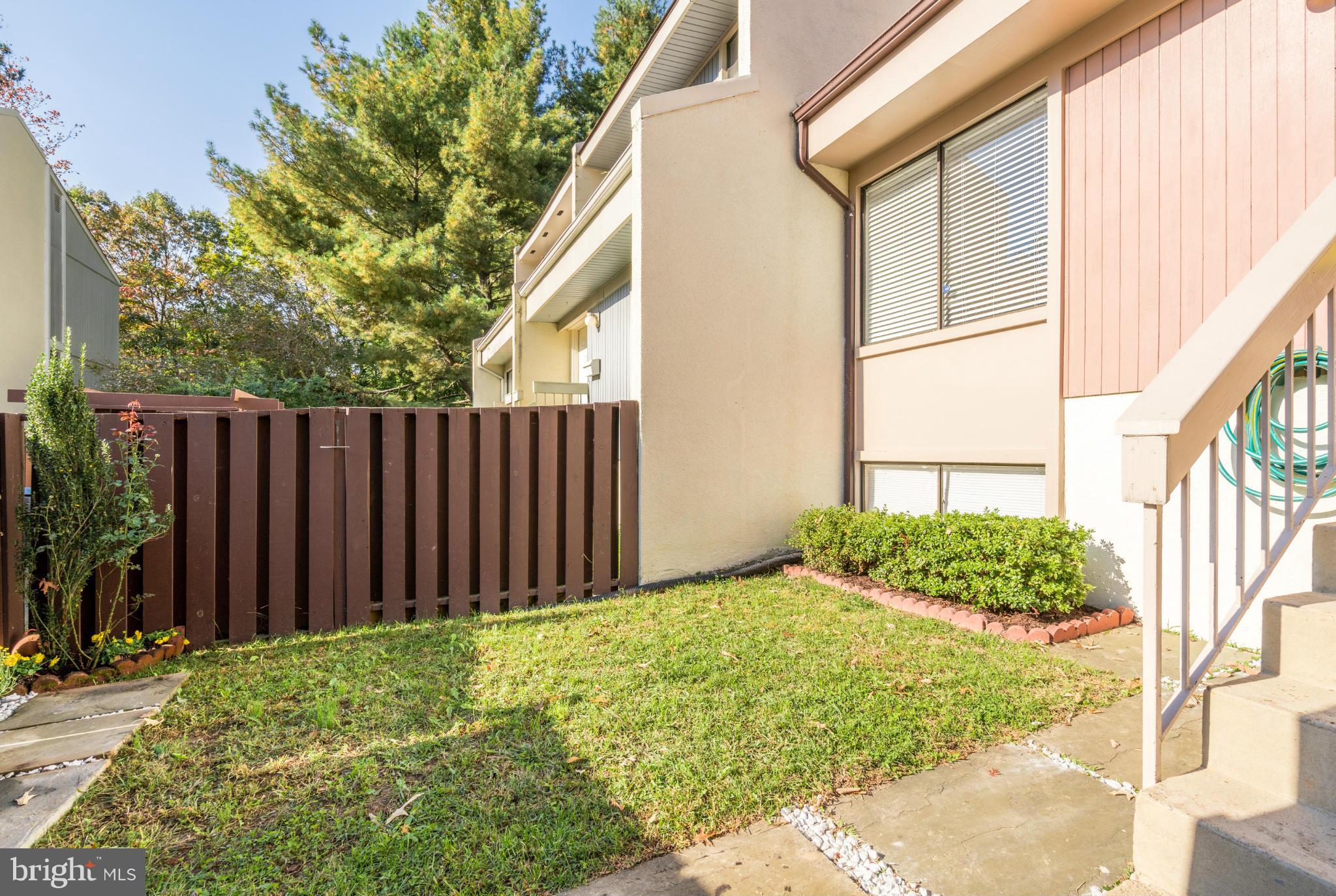 2402 Southgate Square Reston, VA 20191 - Photo 3 of 21 a view of small yard with wooden fence