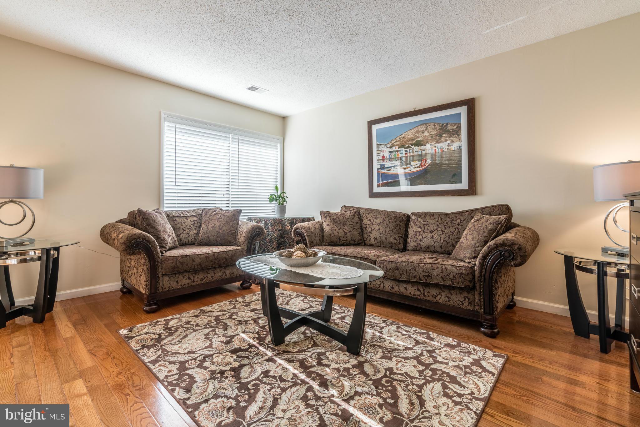 2402 Southgate Square Reston, VA 20191 - Photo 4 of 21 a living room with furniture and wooden floor
