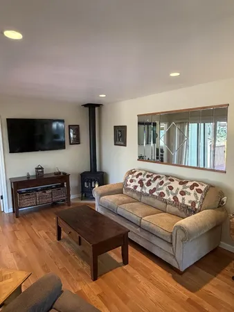 a living room with couches and a flat screen tv