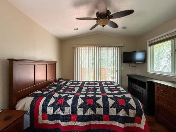 a bedroom with a bed and a chandelier