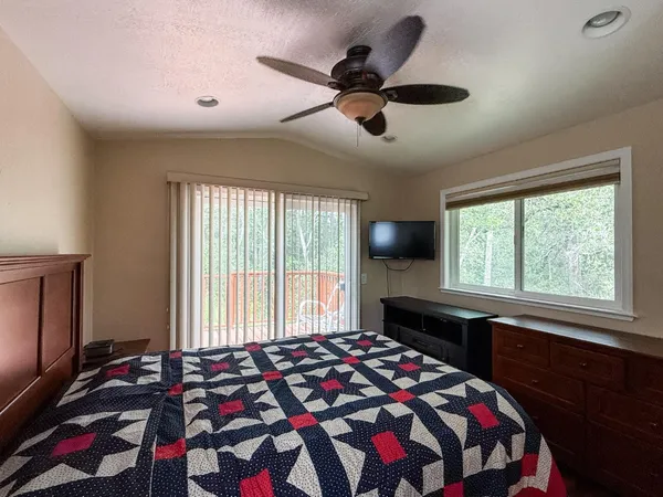 a bedroom with a bed and a window