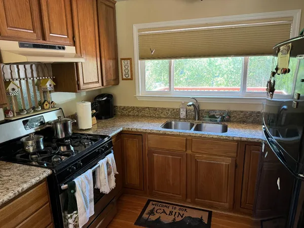 a kitchen with stainless steel appliances a sink stove and cabinets