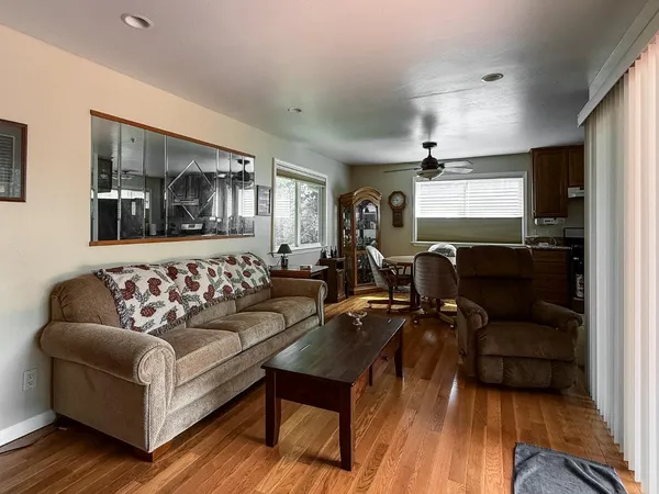 a living room with furniture and a wooden floor