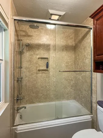 a bathroom with a bathtub and a shower