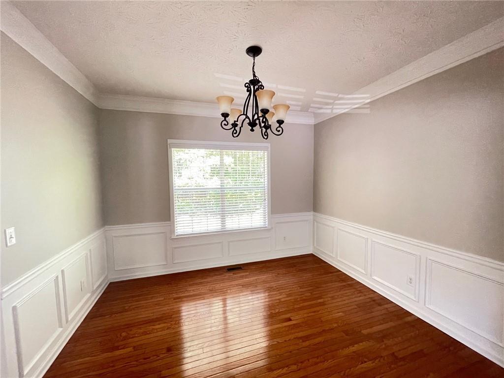 95 Luke Drive Dallas, GA 30132 - Photo 5 of 15 a view of an empty room with wooden floor and a window