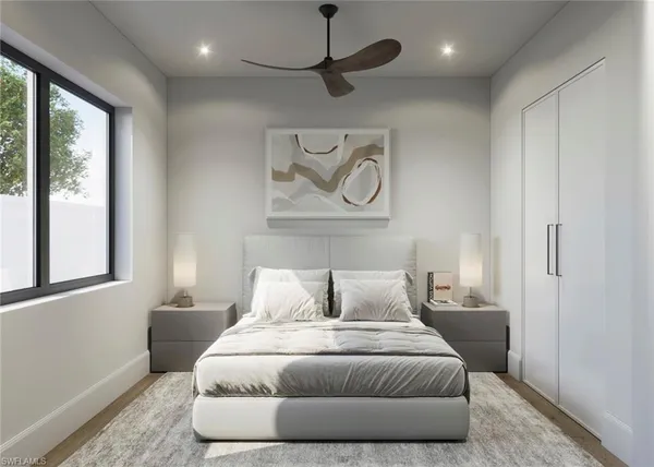 a bedroom with a bed and wooden floor