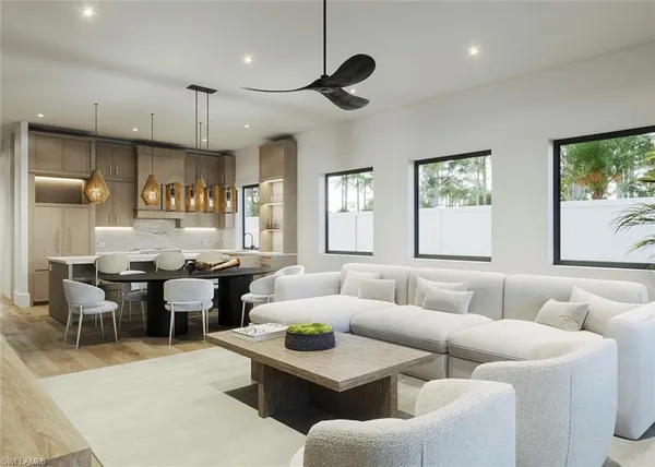 a living room with furniture kitchen view and a large window