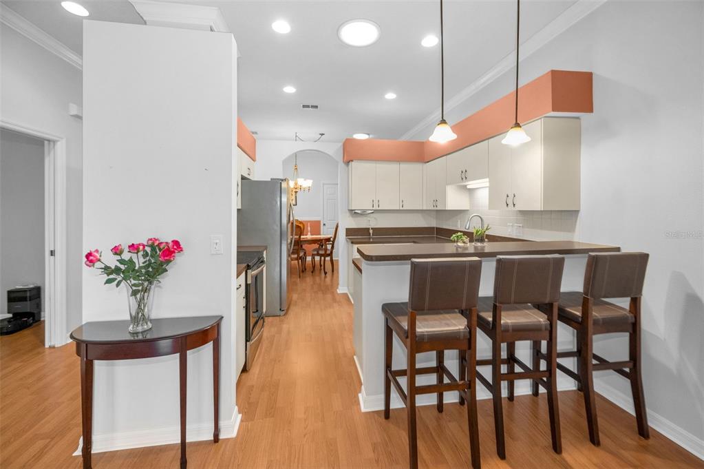12154 Putter Green Court New Port Richey, FL 34654 - Photo 12 of 73 a kitchen with a table and chairs in it