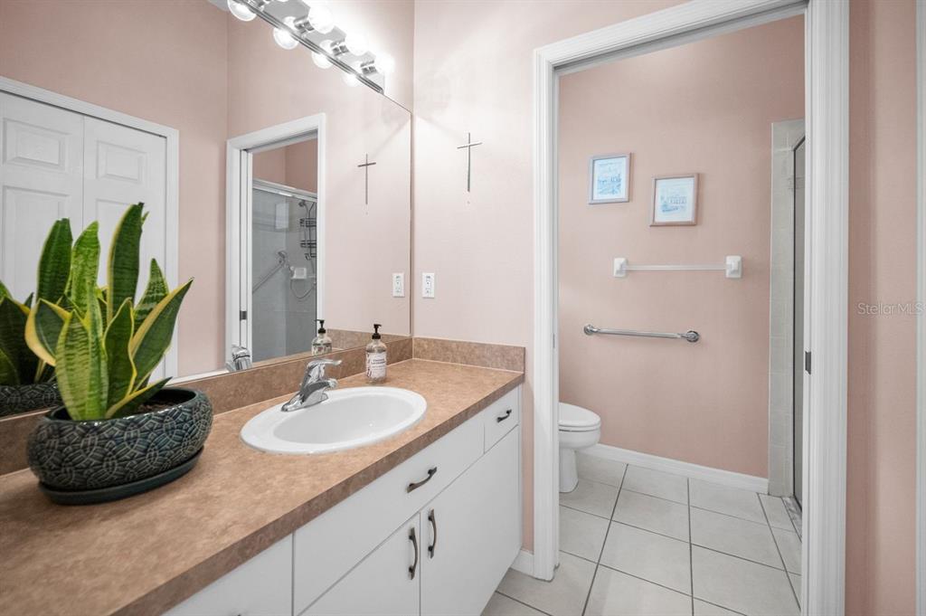 12154 Putter Green Court New Port Richey, FL 34654 - Photo 22 of 73 a bathroom with a granite countertop sink a toilet and a mirror