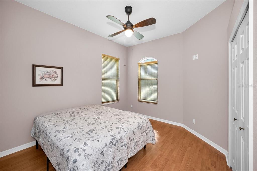 12154 Putter Green Court New Port Richey, FL 34654 - Photo 25 of 73 a bedroom with a bed and a large window