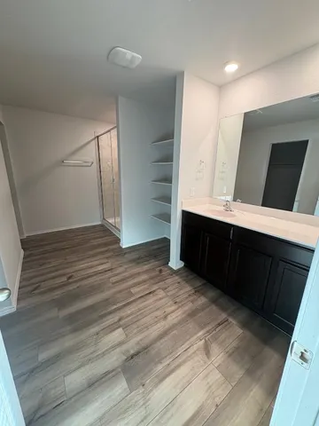 a view of room with wooden floor