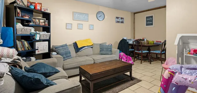 a living room with furniture and a bookshelf