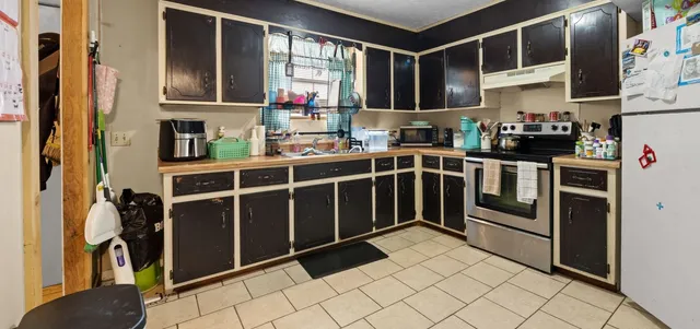 a kitchen with stainless steel appliances granite countertop a stove and a refrigerator
