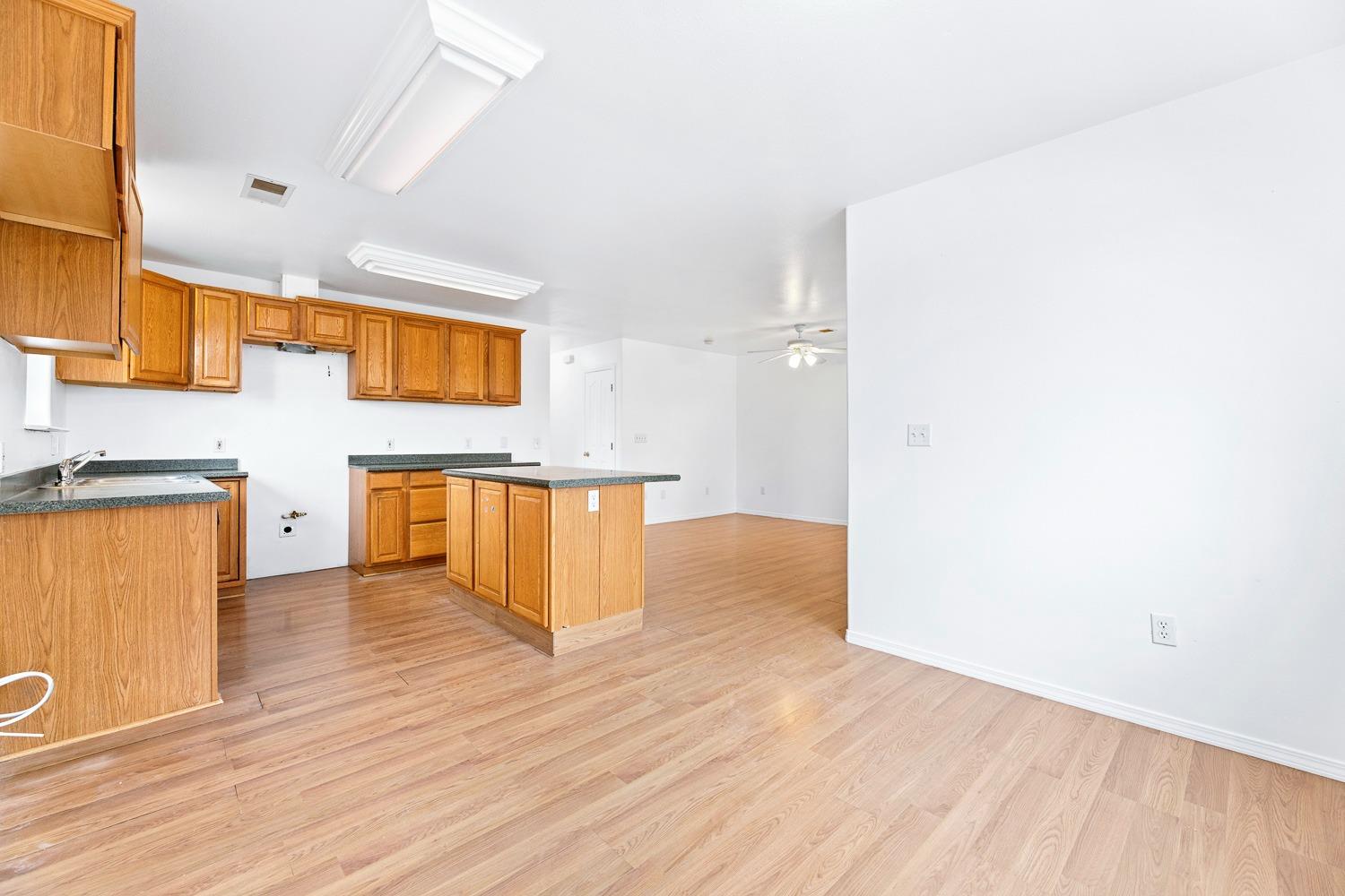 249 Jackson Street Coalinga, CA 93210 - Photo 12 of 42 a view of a kitchen with wooden floor