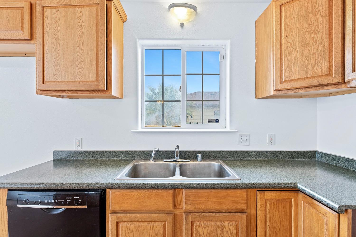 249 Jackson Street Coalinga, CA 93210 - Photo 14 of 42 a kitchen with a sink and cabinets