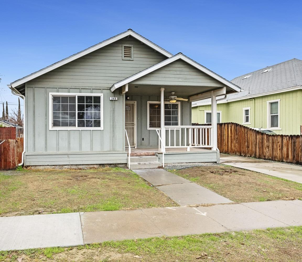 249 Jackson Street Coalinga, CA 93210 - Photo 2 of 42 a front view of a house with a garage