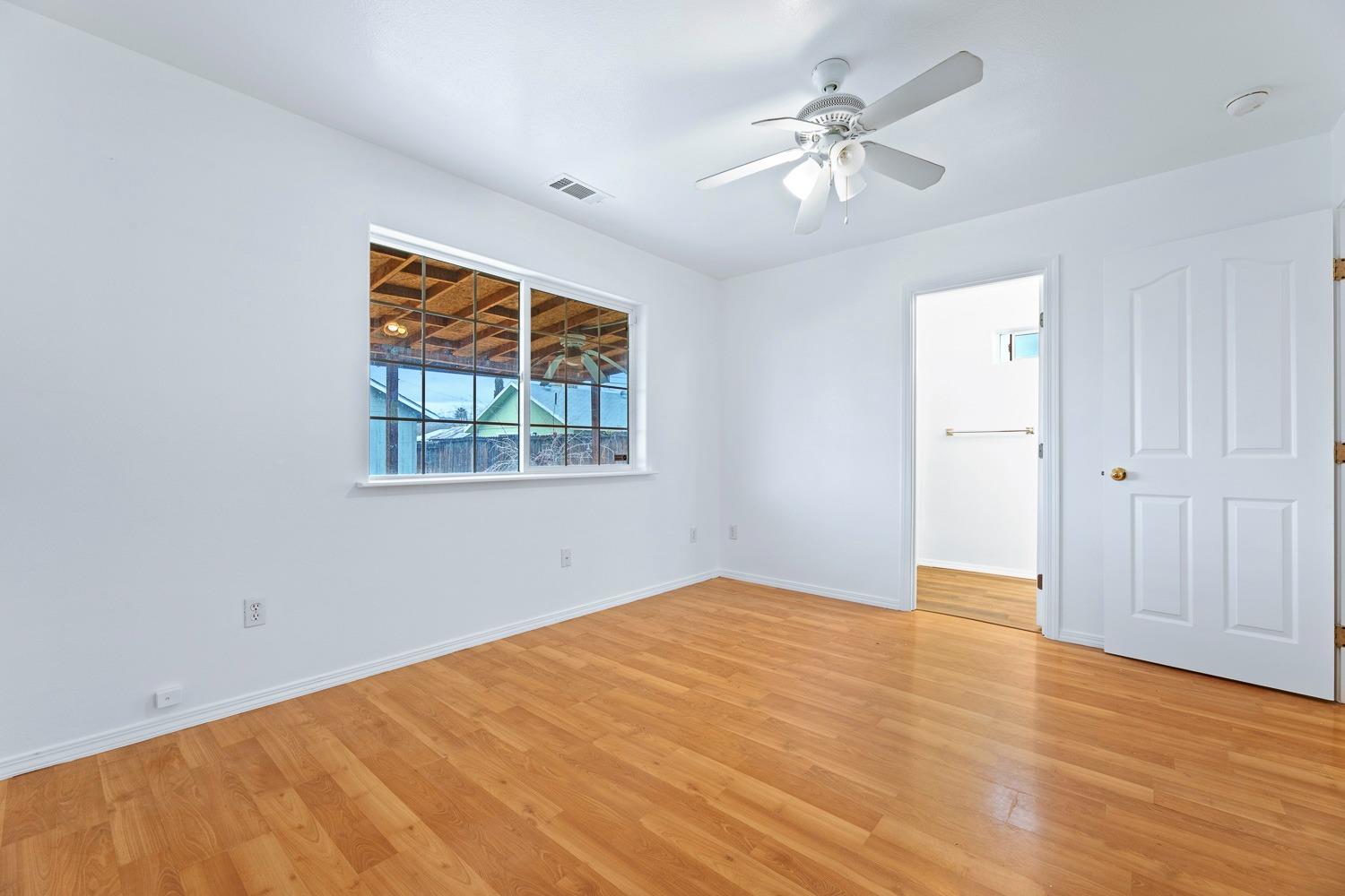 249 Jackson Street Coalinga, CA 93210 - Photo 24 of 42 wooden floor in an empty room with a window