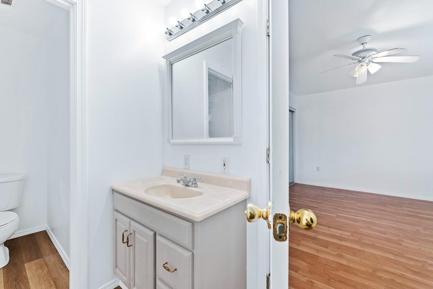 249 Jackson Street Coalinga, CA 93210 - Photo 25 of 42 a bathroom with a sink vanity and a mirror