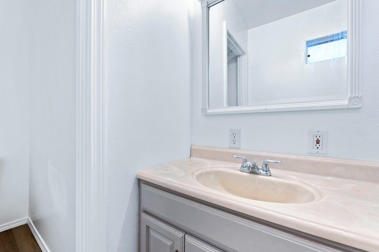 249 Jackson Street Coalinga, CA 93210 - Photo 26 of 42 a bathroom with a sink and a mirror