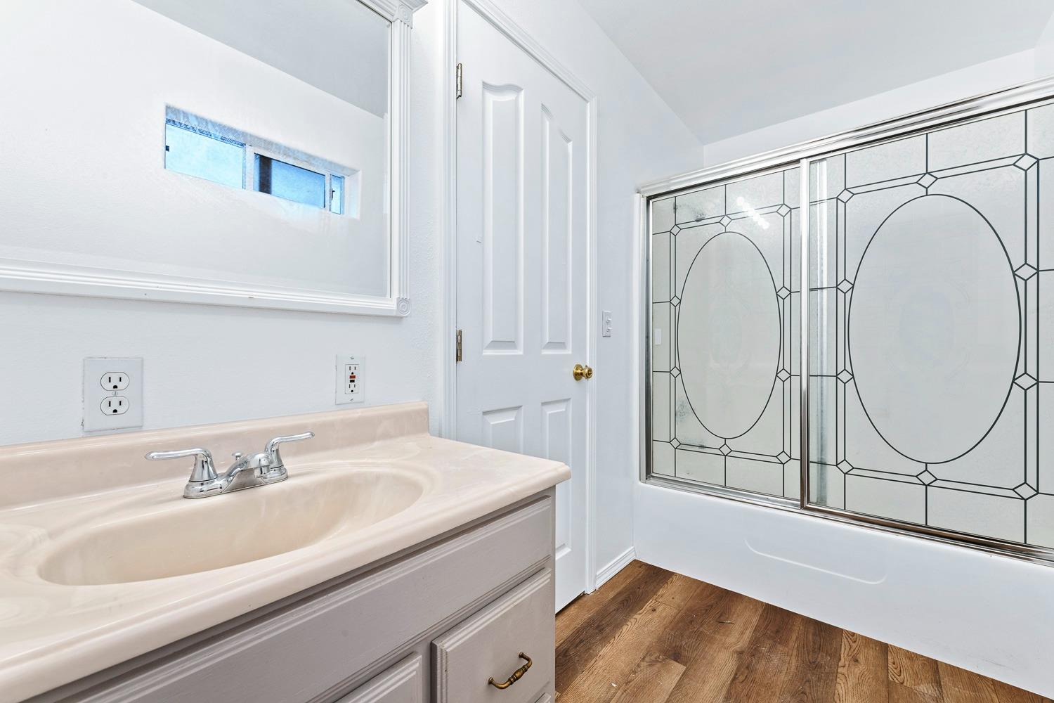 249 Jackson Street Coalinga, CA 93210 - Photo 27 of 42 a bathroom with a sink and a mirror