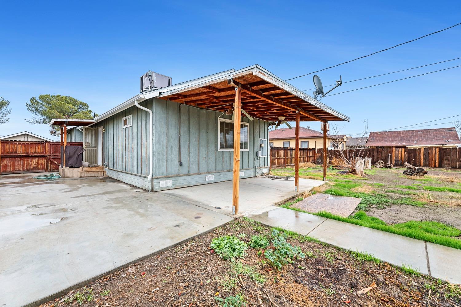 249 Jackson Street Coalinga, CA 93210 - Photo 30 of 42 a patio with a table and chairs under an umbrella
