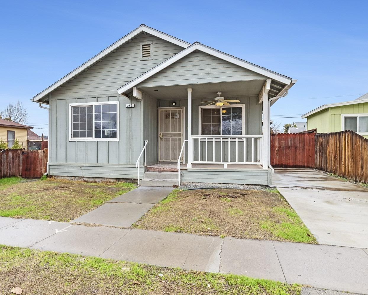 249 Jackson Street Coalinga, CA 93210 - Photo 3 of 42 a front view of a house with a garden and yard