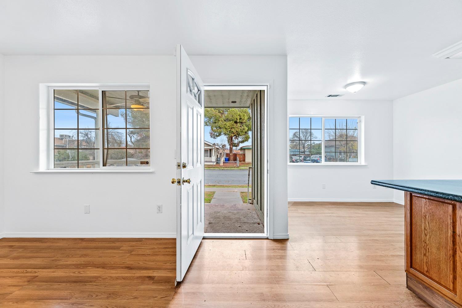 249 Jackson Street Coalinga, CA 93210 - Photo 5 of 42 a view of hallway with livingroom and wooden floor