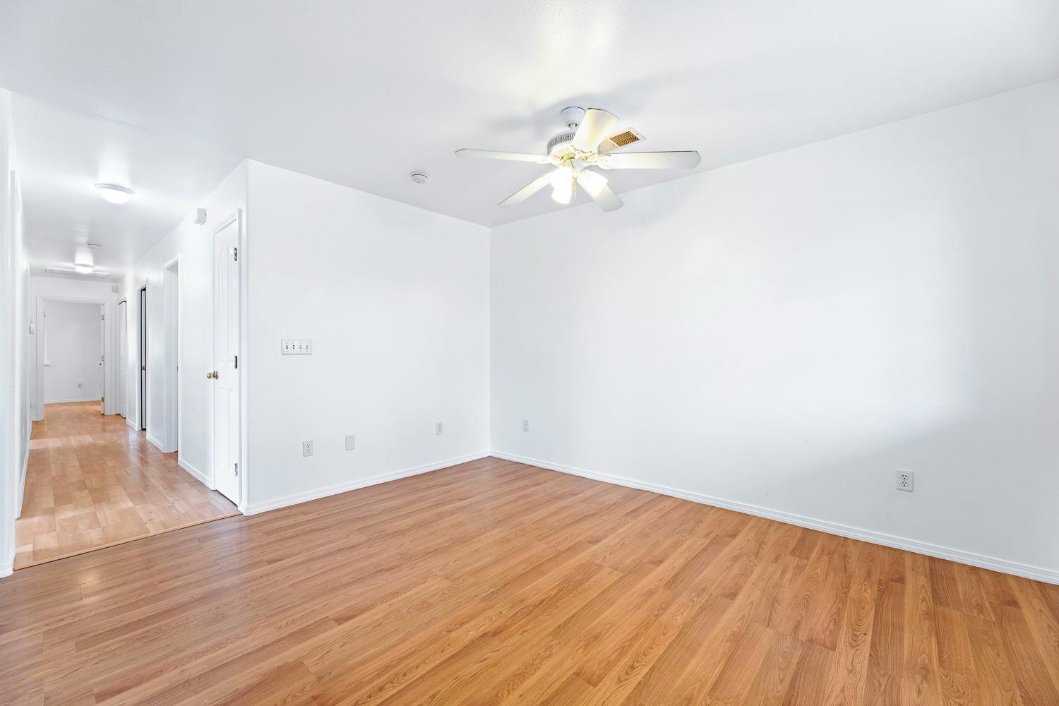 249 Jackson Street Coalinga, CA 93210 - Photo 8 of 42 a view of empty room with wooden floor