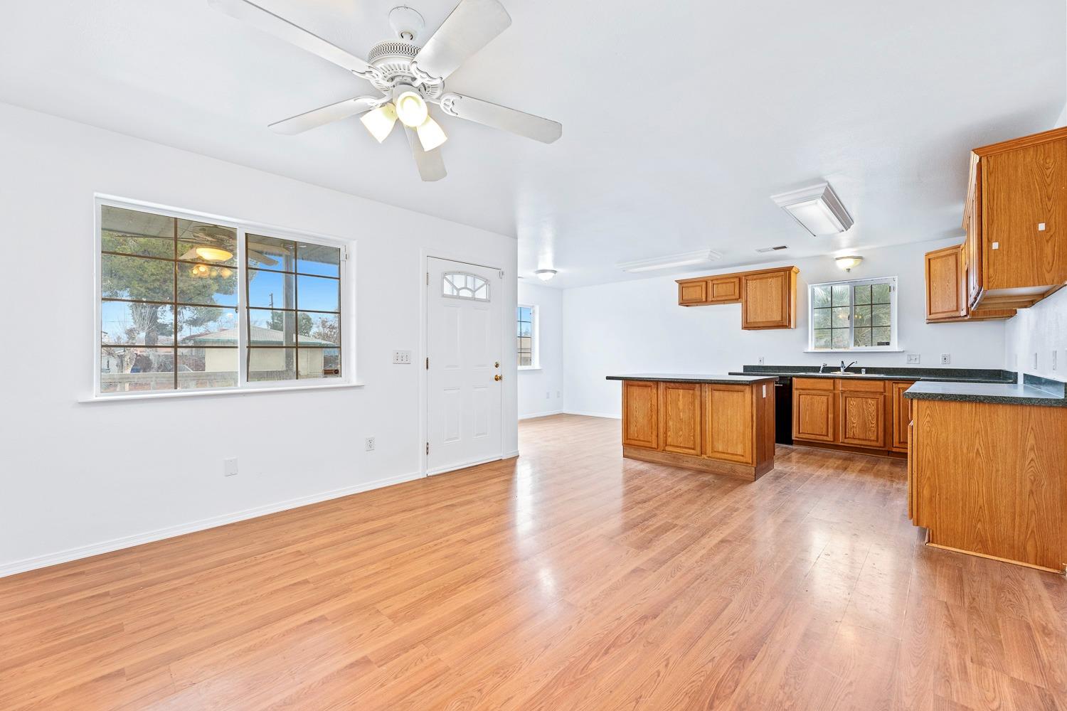 249 Jackson Street Coalinga, CA 93210 - Photo 9 of 42 a view of an empty room with window and wooden floor
