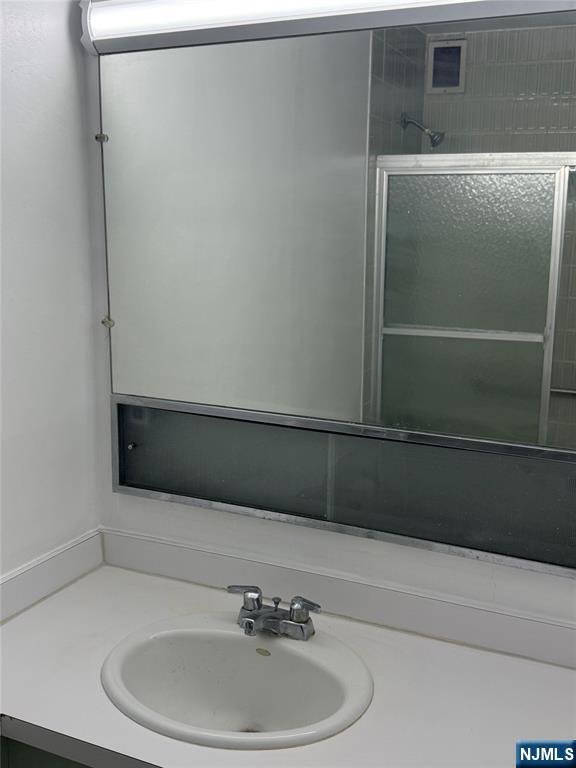280 South Prospect Avenue, Unit 3N Hackensack, NJ 07601 - Photo 14 of 24 a bathroom with a sink and mirror