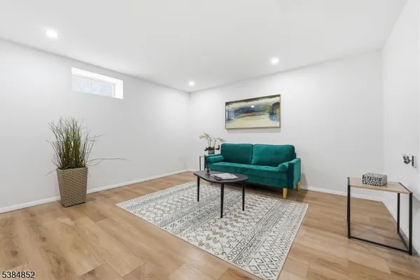 a living room with couch and a potted plant
