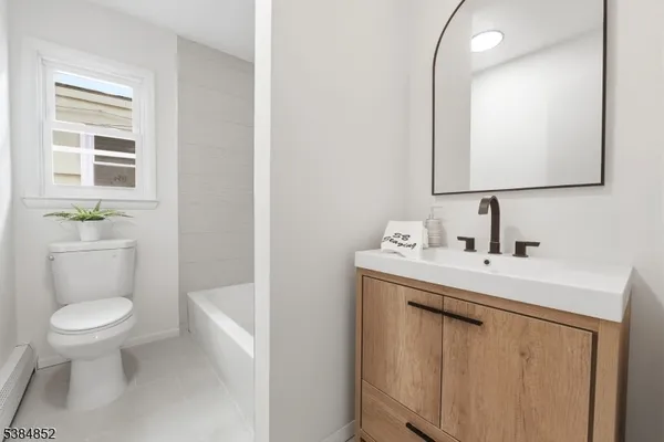 a bathroom with a sink a toilet and mirror