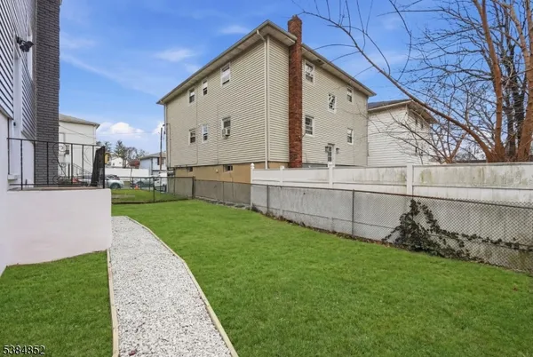 a view of a house with a yard and sitting area