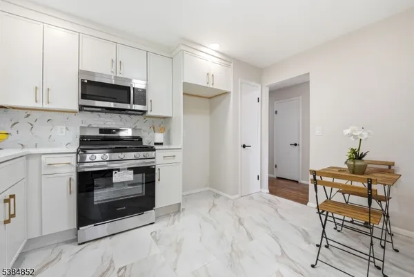 a kitchen with stainless steel appliances a stove a microwave and cabinets