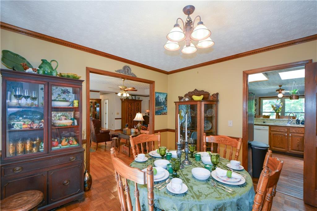 130 Hawn Road Fayetteville, GA 30215 - Photo 15 of 67 a view of a dining room with furniture a rug and wooden floor