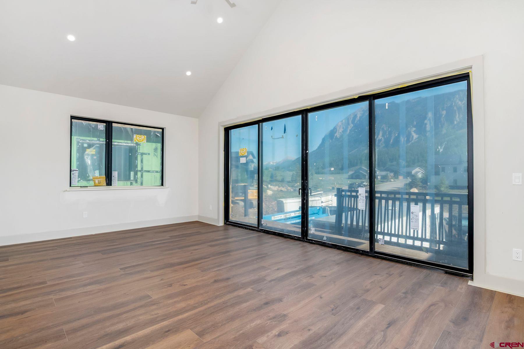 180 Elk Valley Road, Unit 102 Crested Butte, CO 81224 - Photo 5 of 25 a view of an empty room with wooden floor and a window