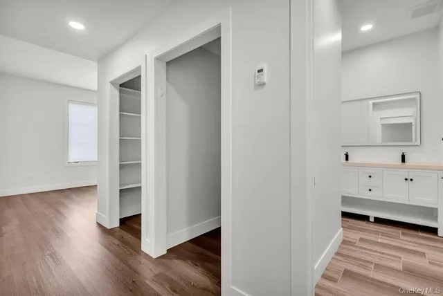 a view of hallway with wooden floor