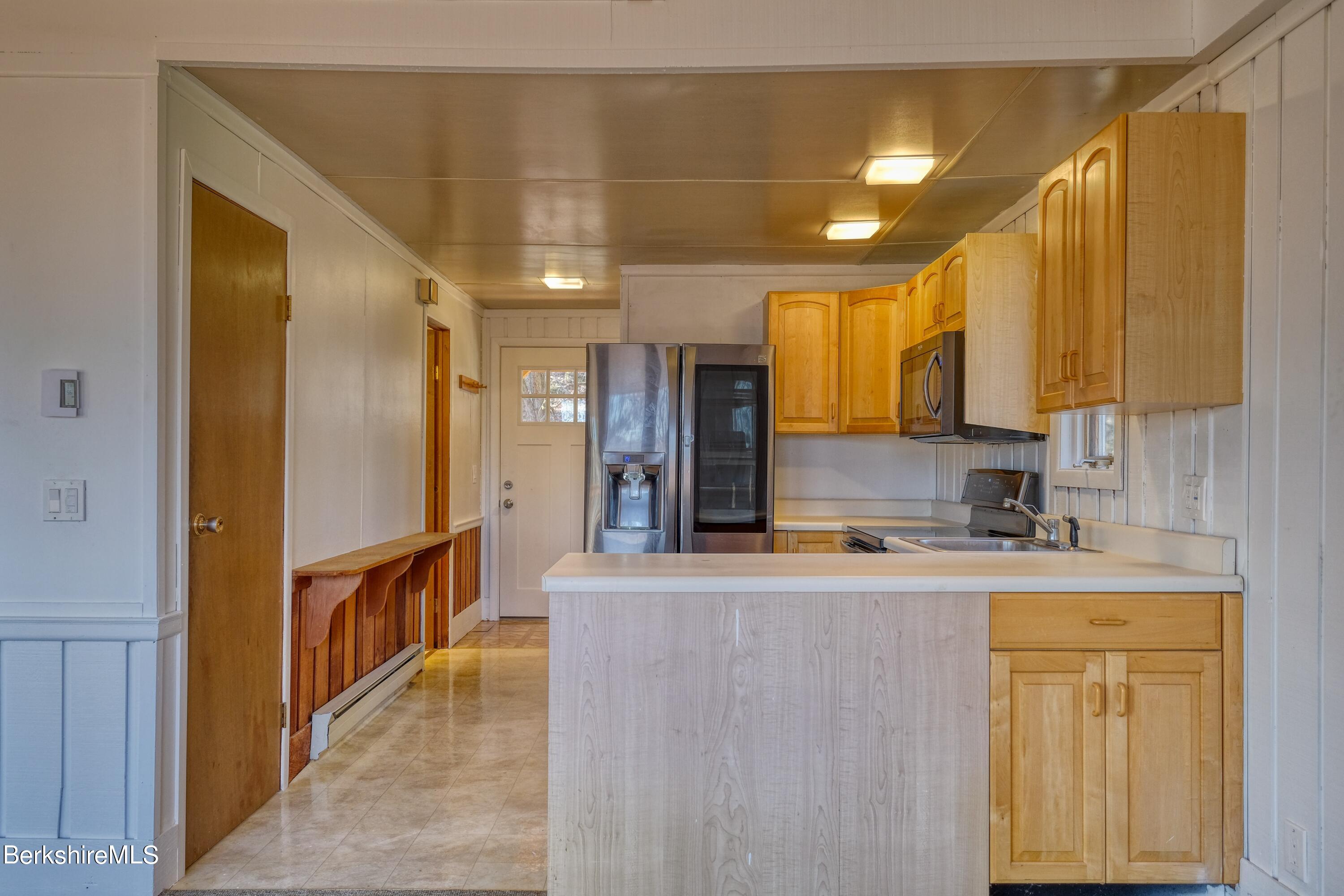 274 East Slope Road Richmond, MA 01201 - Photo 8 of 44 a large kitchen with stainless steel appliances granite countertop a refrigerator a stove and a sink