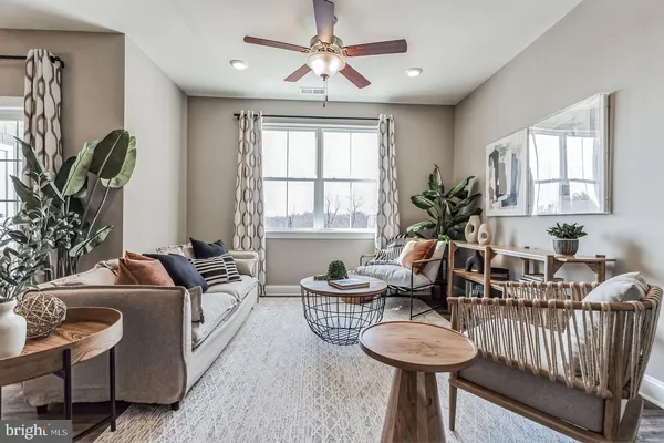a living room with furniture and a large window