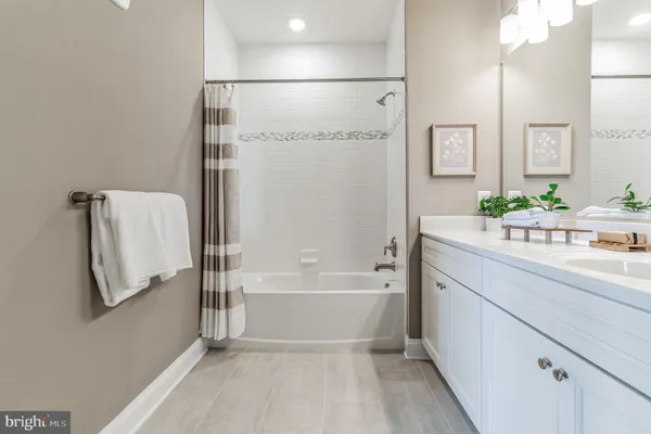 a kitchen with stainless steel appliances granite countertop a dining table chairs sink and cabinets