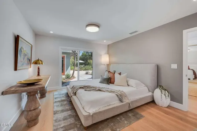 a living room with a bed furniture and a large window