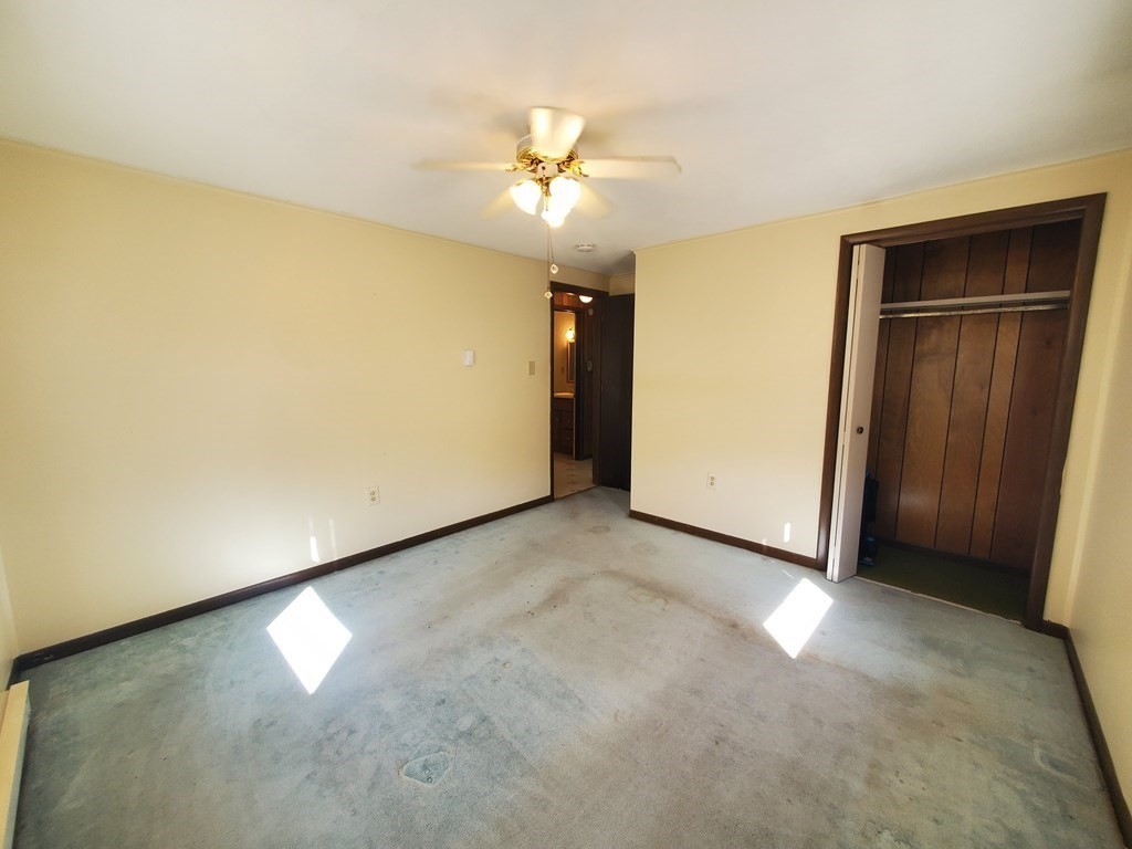 33 Marique Drive Lawrence, MA 01843 - Photo 11 of 20 an empty room with a ceiling fan and a window