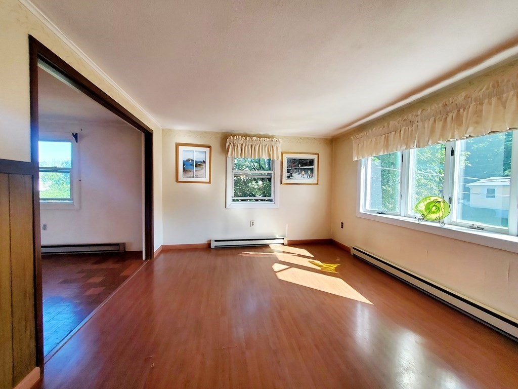 33 Marique Drive Lawrence, MA 01843 - Photo 4 of 20 a view of an empty room with window and wooden floor
