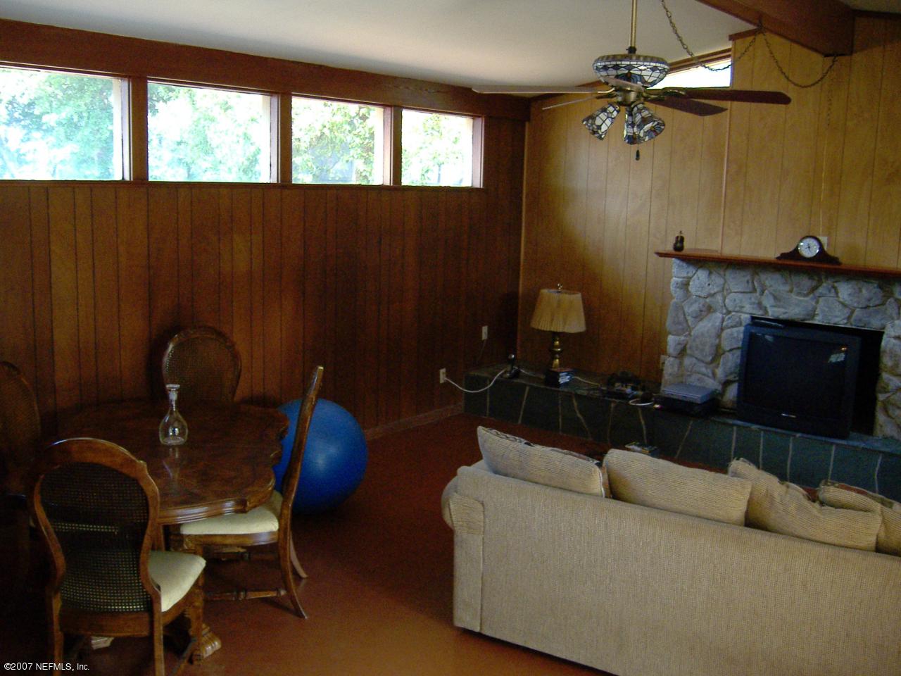 6829 Heidi Road Jacksonville, FL 32277 - Photo 4 of 9 a living room with furniture and a fireplace
