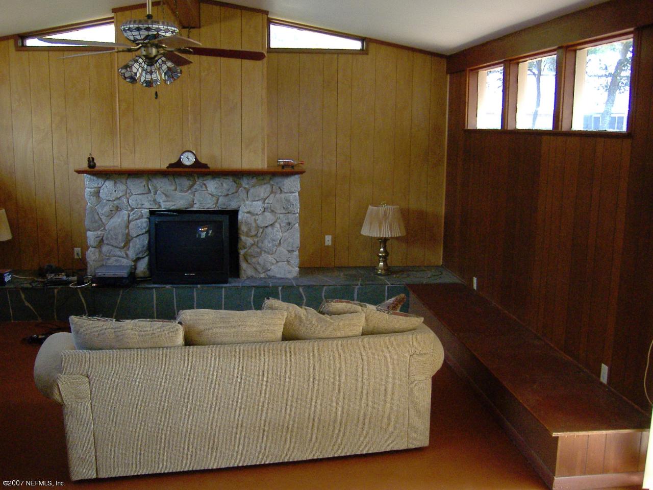 6829 Heidi Road Jacksonville, FL 32277 - Photo 5 of 9 a living room with furniture and a fireplace